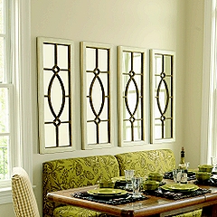 Row of mirrors above a green banquette.